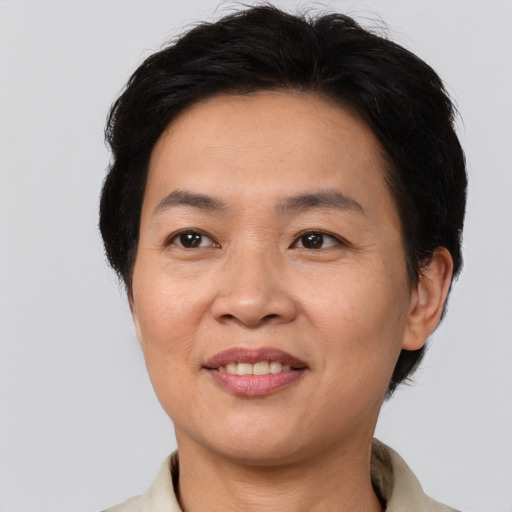 Joyful asian adult female with short  brown hair and brown eyes