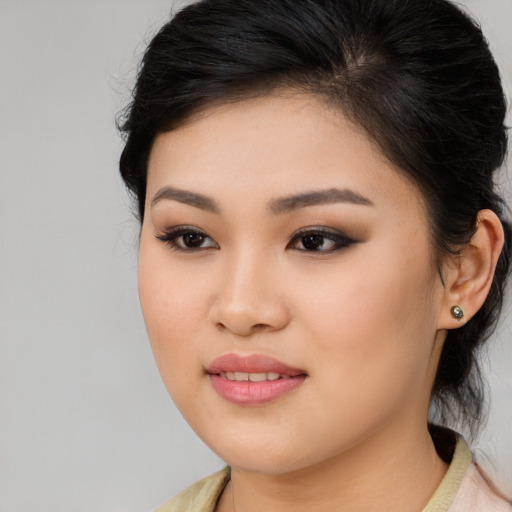 Joyful asian young-adult female with medium  brown hair and brown eyes