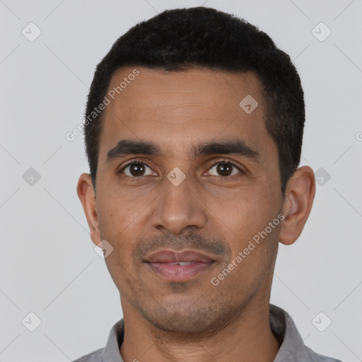 Joyful latino young-adult male with short  black hair and brown eyes