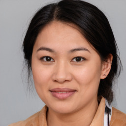 Joyful asian young-adult female with medium  brown hair and brown eyes