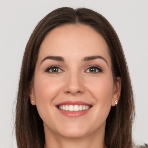 Joyful white young-adult female with long  brown hair and grey eyes