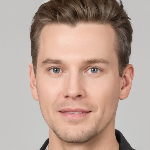 Joyful white young-adult male with short  brown hair and grey eyes