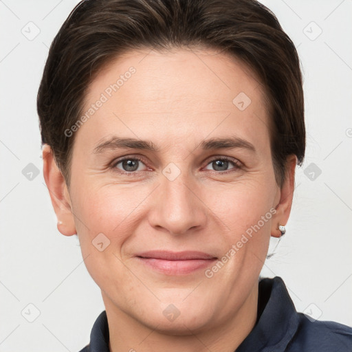 Joyful white adult female with short  brown hair and grey eyes