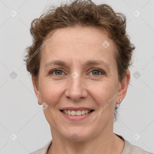 Joyful white adult female with short  brown hair and grey eyes