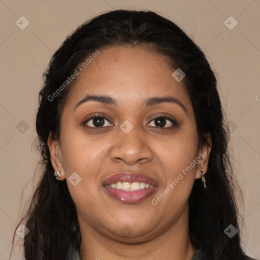 Joyful black young-adult female with long  brown hair and brown eyes