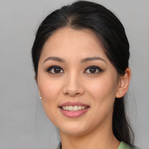 Joyful white young-adult female with medium  brown hair and brown eyes