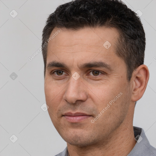 Joyful white adult male with short  brown hair and brown eyes