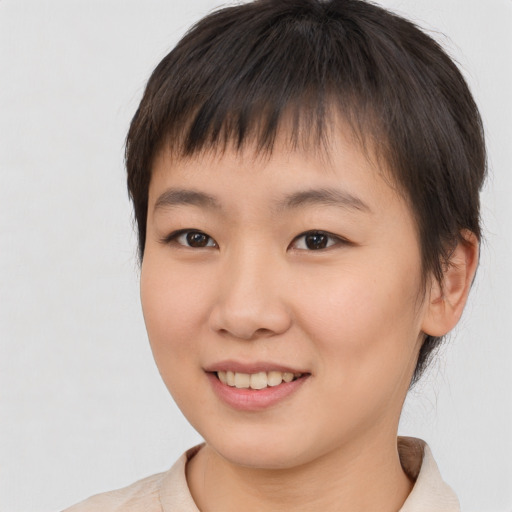 Joyful asian young-adult female with short  brown hair and brown eyes