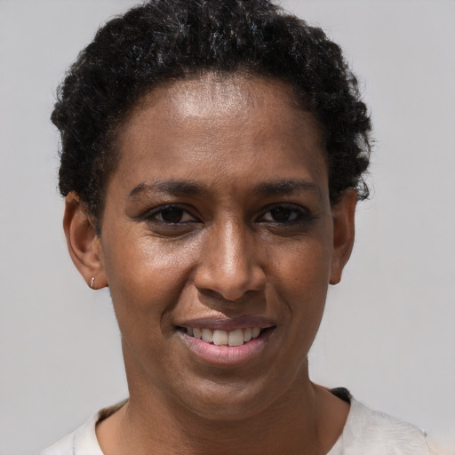 Joyful black young-adult female with short  brown hair and brown eyes
