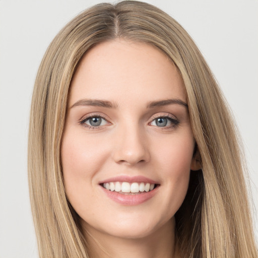 Joyful white young-adult female with long  brown hair and green eyes