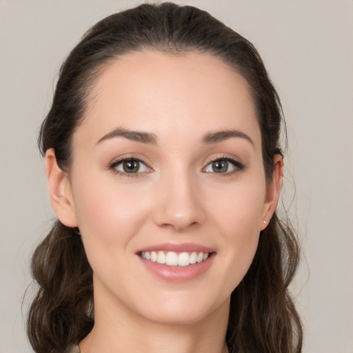 Joyful white young-adult female with medium  brown hair and grey eyes