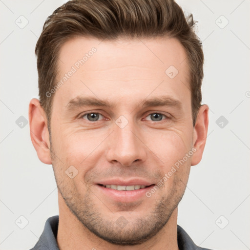 Joyful white young-adult male with short  brown hair and grey eyes