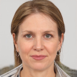 Joyful white adult female with medium  brown hair and grey eyes