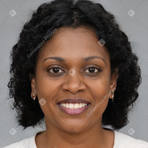 Joyful black young-adult female with long  brown hair and brown eyes