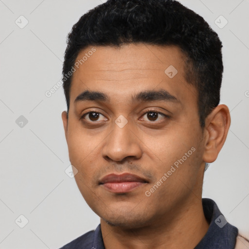 Joyful latino young-adult male with short  black hair and brown eyes