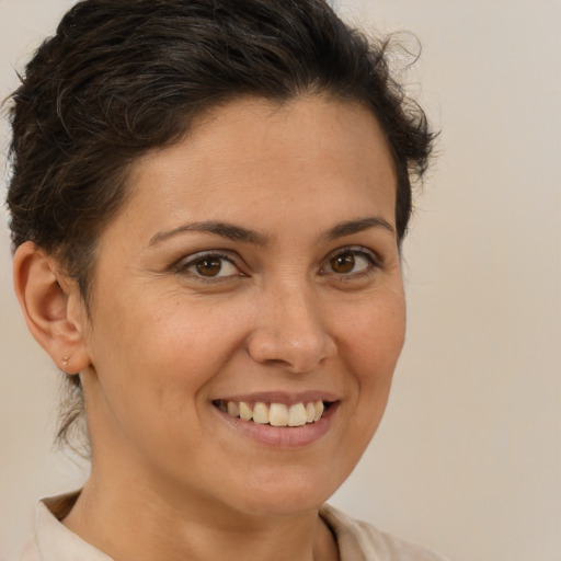 Joyful white adult female with short  brown hair and brown eyes