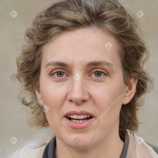 Joyful white adult female with medium  brown hair and blue eyes