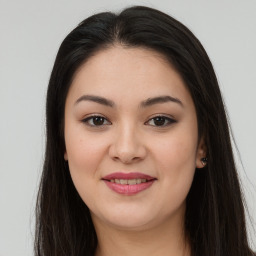 Joyful latino young-adult female with long  brown hair and brown eyes