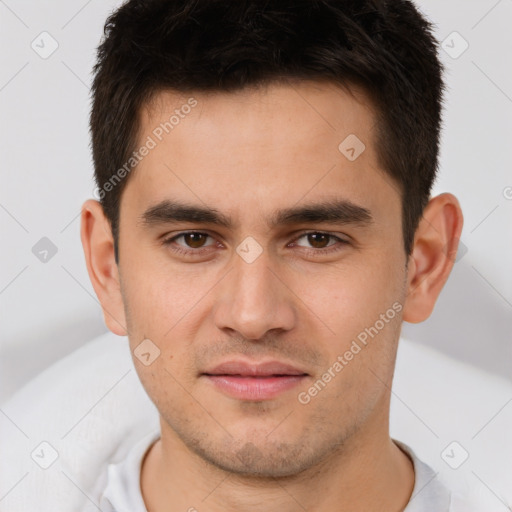 Joyful white young-adult male with short  brown hair and brown eyes