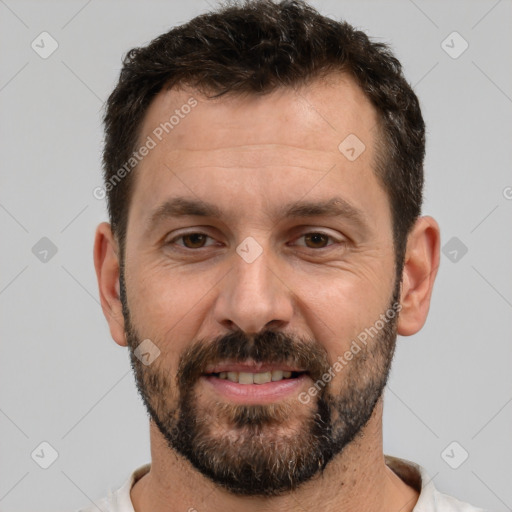 Joyful white adult male with short  black hair and brown eyes