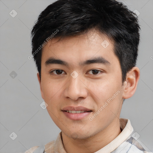 Joyful asian young-adult male with short  black hair and brown eyes