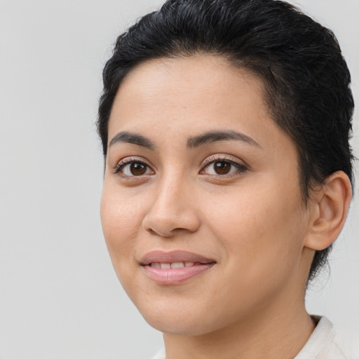 Joyful latino young-adult female with short  brown hair and brown eyes