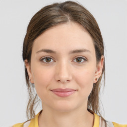 Joyful white young-adult female with medium  brown hair and brown eyes