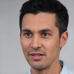 Joyful white young-adult male with short  black hair and brown eyes