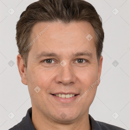 Joyful white adult male with short  brown hair and brown eyes