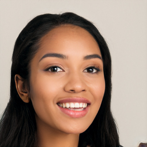 Joyful latino young-adult female with long  black hair and brown eyes