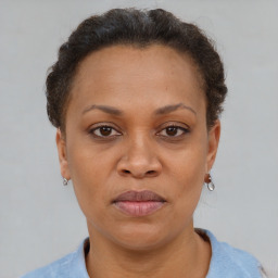 Joyful black adult female with short  brown hair and brown eyes