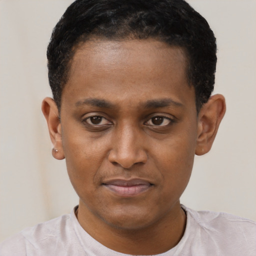 Joyful latino young-adult male with short  brown hair and brown eyes