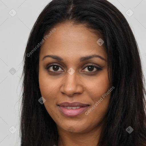 Joyful black young-adult female with long  brown hair and brown eyes