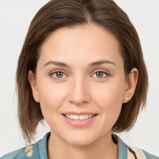 Joyful white young-adult female with medium  brown hair and grey eyes