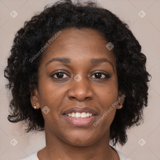 Joyful black adult female with medium  brown hair and brown eyes