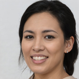 Joyful latino young-adult female with medium  brown hair and brown eyes