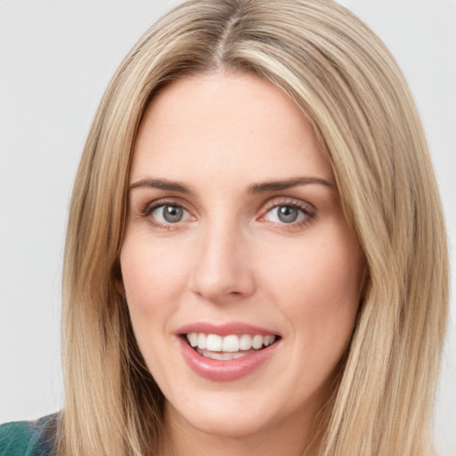 Joyful white young-adult female with long  brown hair and green eyes