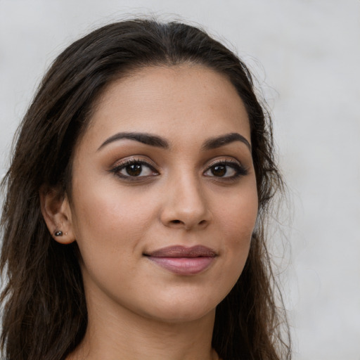 Joyful latino young-adult female with long  brown hair and brown eyes
