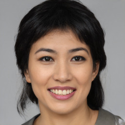 Joyful asian young-adult female with medium  black hair and brown eyes