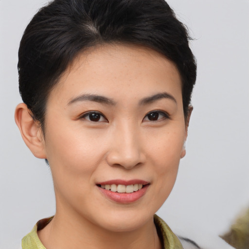 Joyful asian young-adult female with short  brown hair and brown eyes