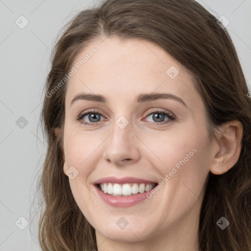 Joyful white young-adult female with long  brown hair and grey eyes