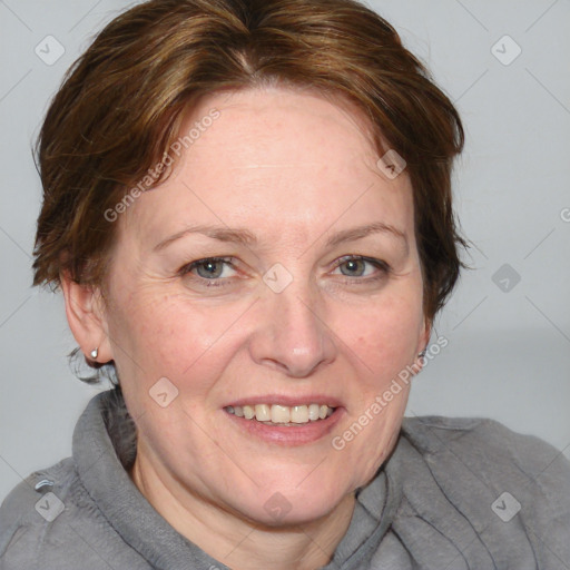 Joyful white adult female with medium  brown hair and blue eyes