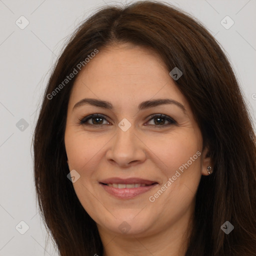 Joyful white adult female with long  brown hair and brown eyes