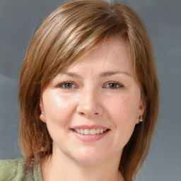 Joyful white young-adult female with medium  brown hair and brown eyes