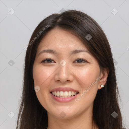 Joyful white young-adult female with long  brown hair and brown eyes