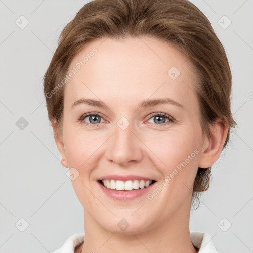 Joyful white young-adult female with short  brown hair and grey eyes