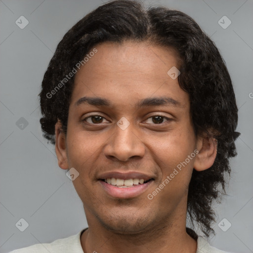 Joyful latino young-adult male with short  brown hair and brown eyes