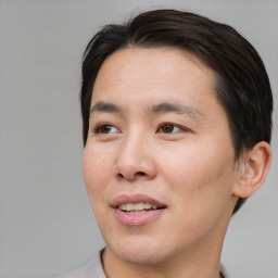 Joyful asian young-adult male with short  brown hair and brown eyes