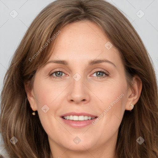 Joyful white adult female with long  brown hair and grey eyes