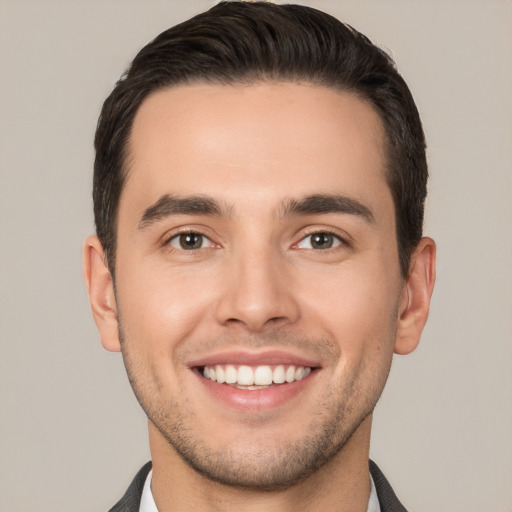 Joyful white young-adult male with short  brown hair and brown eyes